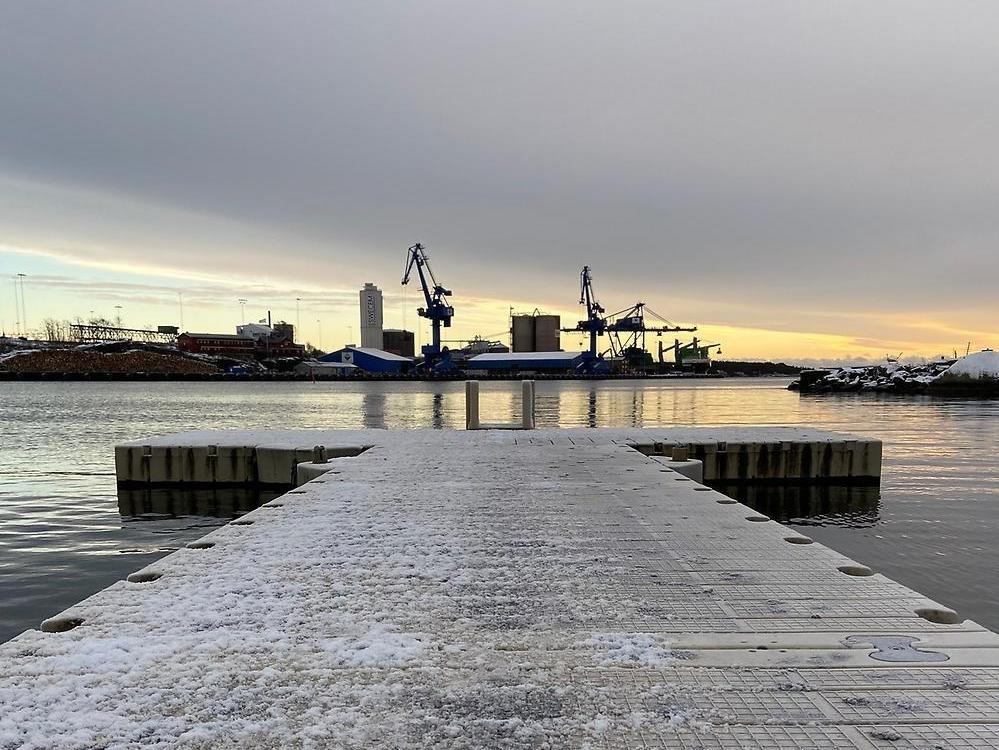 Brygga och badstege på vintern med bakgrund mot hamnen